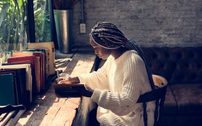 Photo of woman writing for article launching discoveries programme