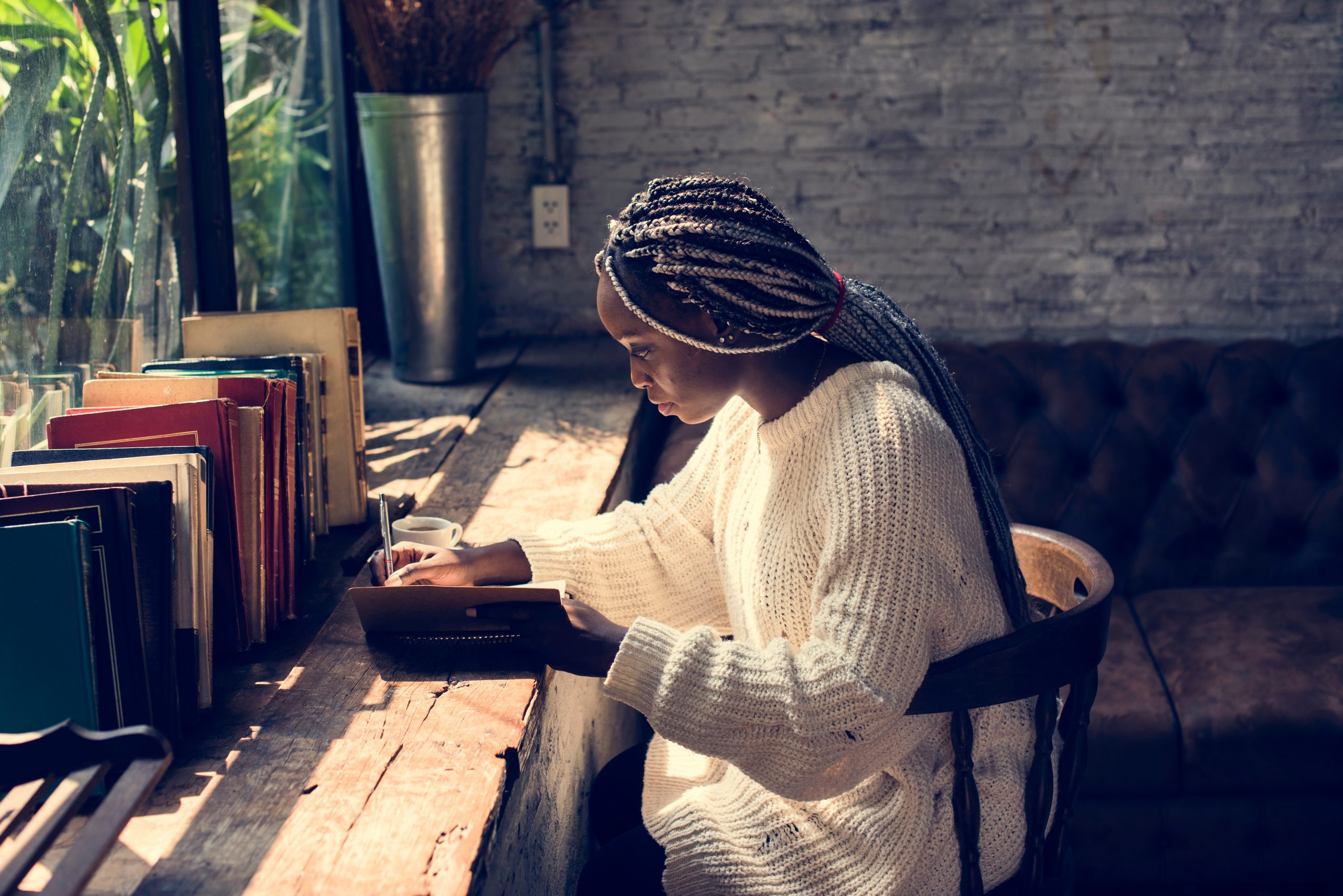 Photo of woman writing for article launching discoveries programme